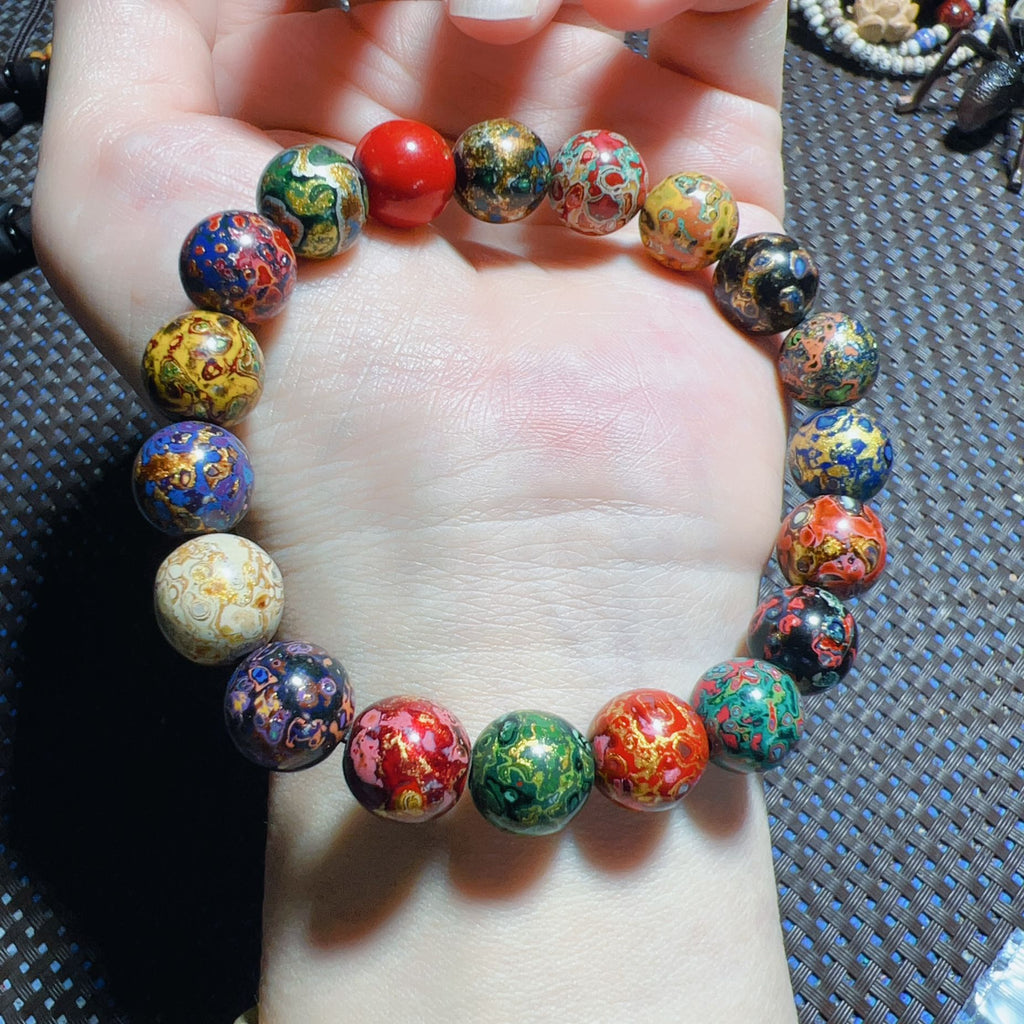 Colorful handmade lacquer bracelet 8mm worn on wrist alongside spiritual bracelet collection showing multicolor lacquer patterns Taoist KaiGuang wealth attraction protection