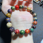 Colorful handmade lacquer bracelet 8mm worn on wrist alongside spiritual bracelet collection showing multicolor lacquer patterns Taoist KaiGuang wealth attraction protection