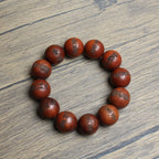 Consecrated Zitan Fulu bracelet displayed on a traditional wooden surface, a Taoist safekeeping vessel.