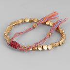 copper bead bracelet women taoist kaiguang wealth love aura gold beads red rope angle detail white background