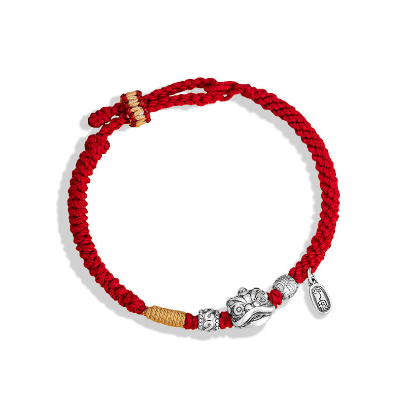  Red and gold braided cord love protection bracelet with silver lion head charm rune beads and oval tag on white background Taoist KaiGuang couple jewelry