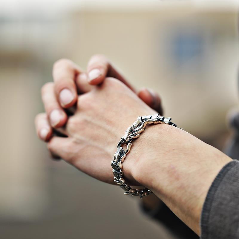 man wearing dragon titanium bracelet prayer hands taoist kaiguang amulet spiritual shield protection energy cleansing