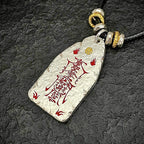 Macro shot of the supreme evil-banishing symbols on the back of the hammered silver pendant.