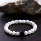Detailed texture of white turquoise beads in yin yang feng shui bracelet, highlighting unique natural patterns on each bead