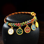 Five Gods of Wealth bracelet five-color enamel gold medallions displayed on black stone Taoist KaiGuang fortune bracelet