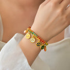 Five Gods of Wealth bracelet worn on woman wrist colorful braided rope gold medallion charms fortune jewelry lifestyle