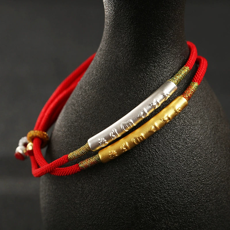 Gold and silver mantra tube red rope KaiGuang protection bracelet two variants layered on display