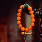 A detailed macro shot of translucent Golden Armor Agate beads and artisan spacers on a Taoist amulet, functioning as an energy shield.