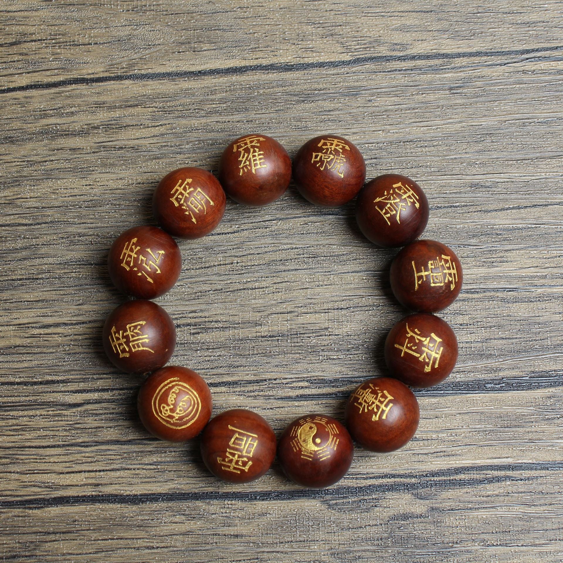 Close-up of hand-engraved Taoist 讳 (Hui) runes and Eight Trigrams on natural thunderstruck wood beads.