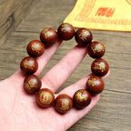 Hand wearing Taoist Five Thunder Command bracelet made of consecrated thunderstruck jujube wood for spiritual protection.