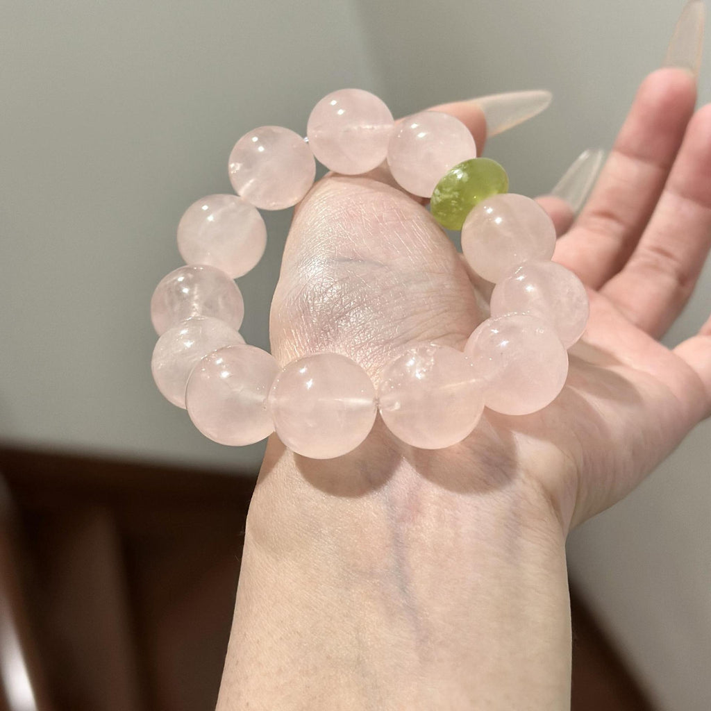A woman wearing a consecrated rose quartz and peridot bracelet for inner grace.
