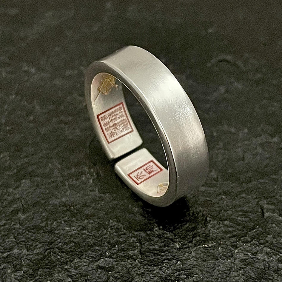 Close-up of the sacred cinnabar-filled talismans inside the ring for spiritual energy activation.
