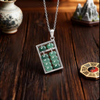 jade abacus pendant collection flatlay dark wood taoist kaiguang wealth attraction fortune