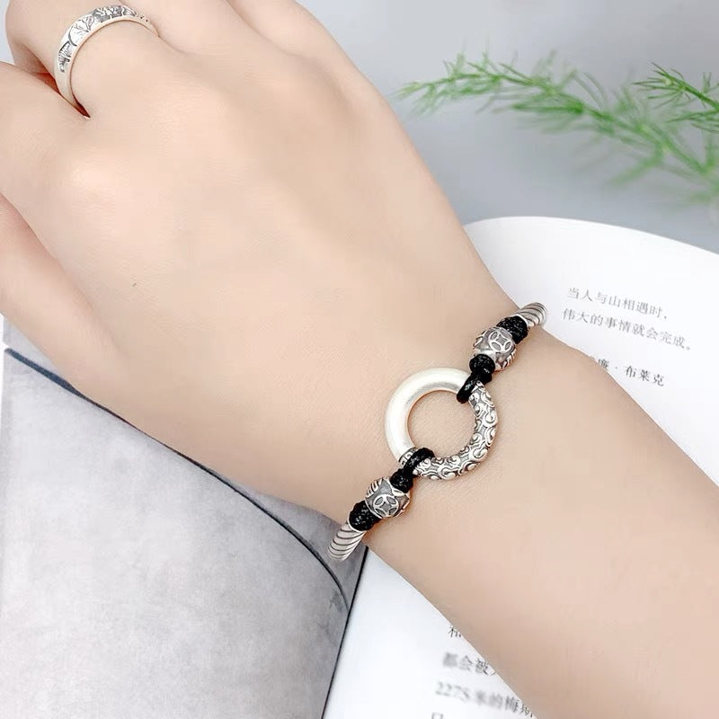 Woman wearing Taoist KaiGuang jade peace buckle protection bracelet — spiritual protection amulet wrist wear