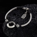 Taoist KaiGuang jade peace buckle protection bracelet — evil warding amulet on natural stone display