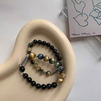 Taoist blessed Black Obsidian and Tiger Eye love protection bracelets displayed on tray with premium presentation
