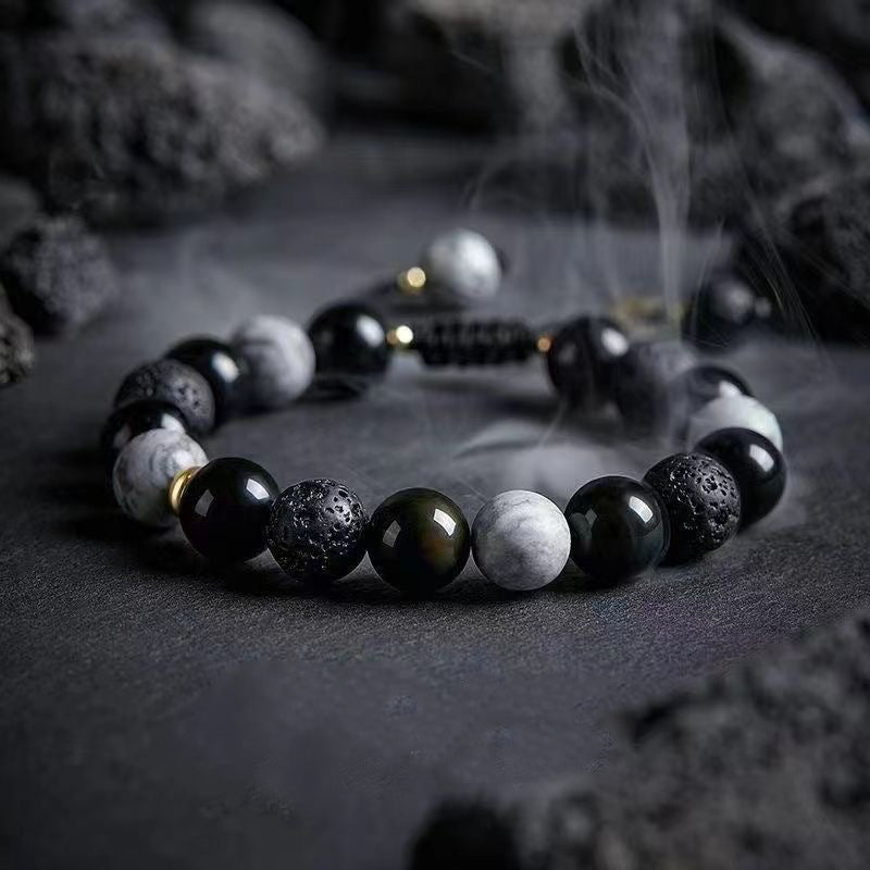 Detailed view of Taoist Kaiguang obsidian bracelet with volcanic lava stone energy bea
