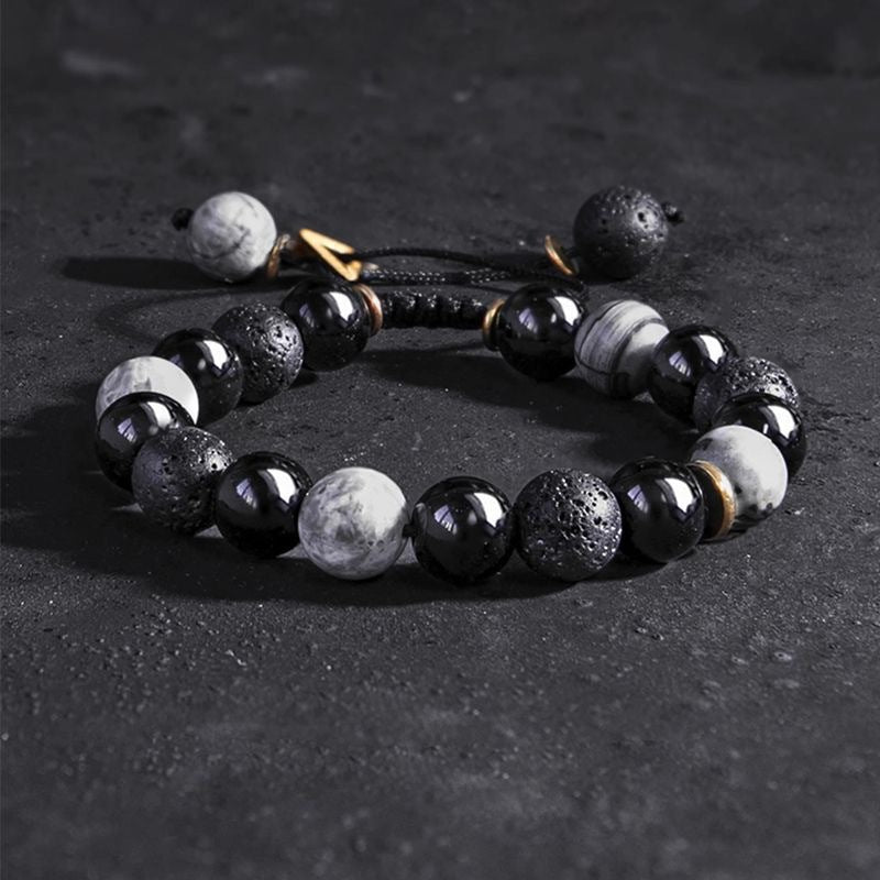 Taoist Kaiguang obsidian bracelet full view flat lay showing volcanic lava stone and protection beads