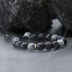 Horizontal view of Taoist Kaiguang obsidian bracelet showing full energy balance design