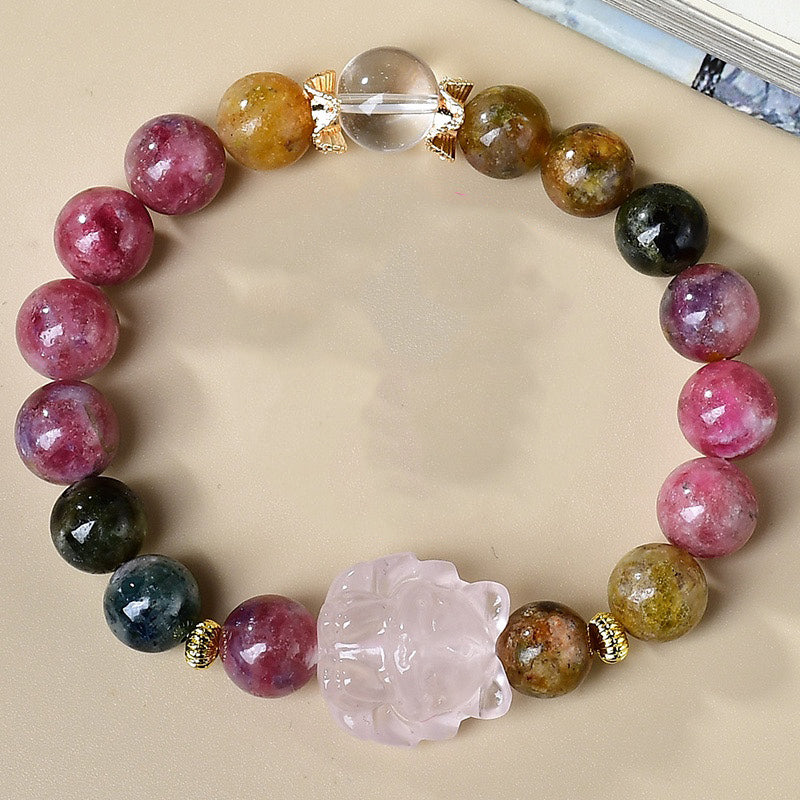 Overhead view rainbow tourmaline love attraction crystal bracelet rose quartz nine-tail fox carving clear quartz ball gold spacers arranged in circle cream background Taoist KaiGuang
