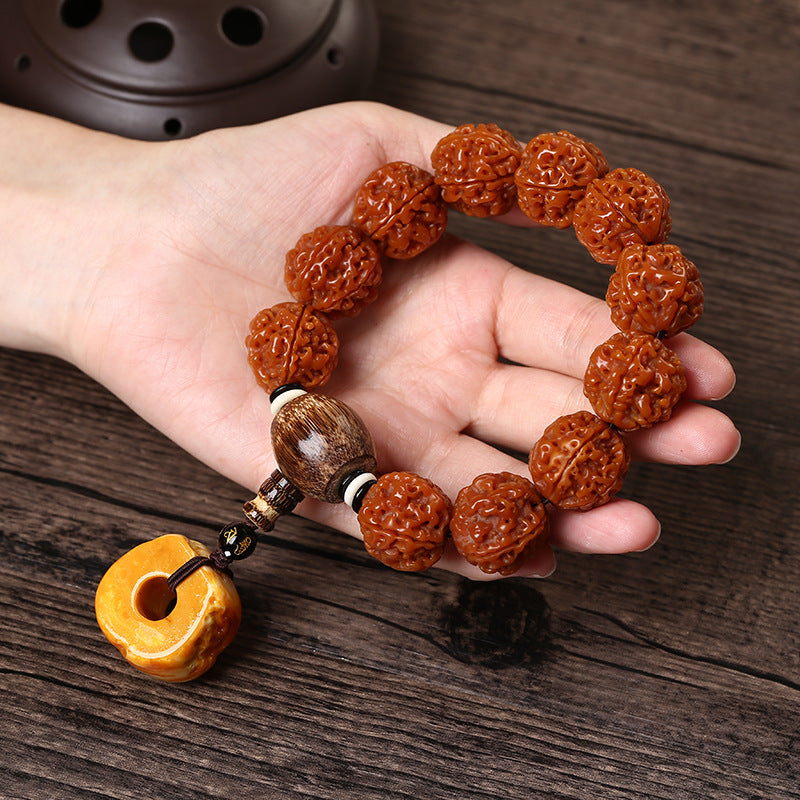 Perspective view of the Walnut bracelet being held for energy cleansing.