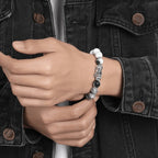 man wearing map stone pixiu bracelet wrist taoist kaiguang wealth fortune career success dark jacket