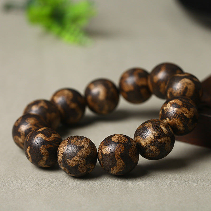 Close-up of men's luxury tiger stripe agarwood bracelet 18mm showing gold brown tiger stripe grain detail Taoist KaiGuang wealth attraction meditation stress relief men's spiritual bracelet