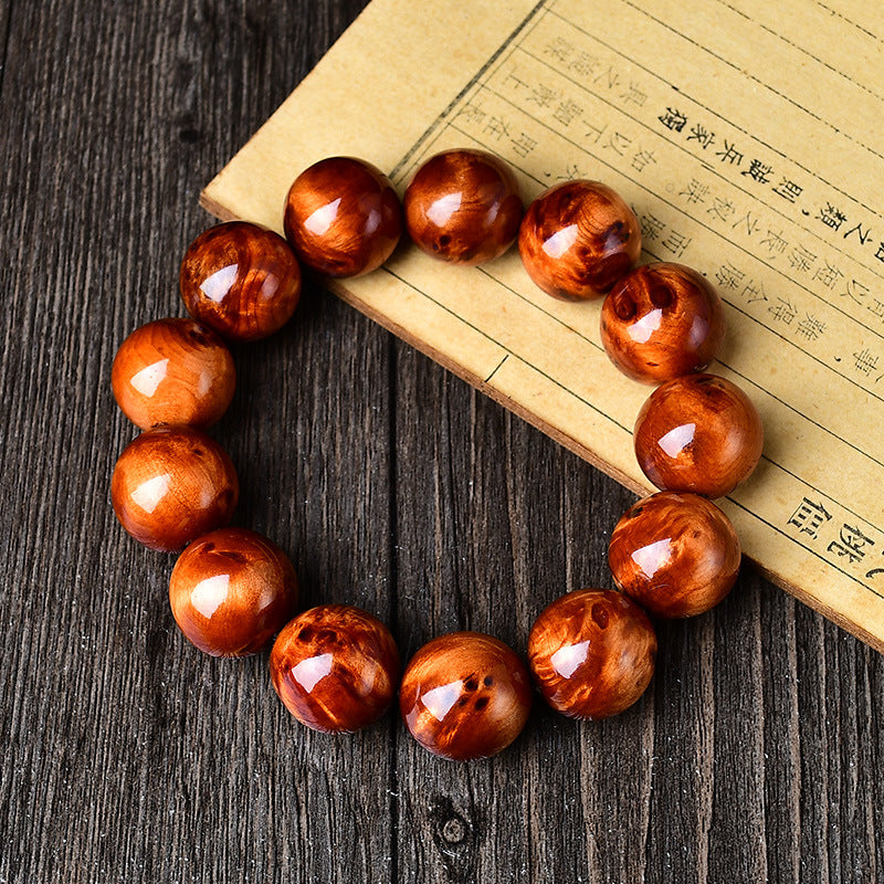 Men's stress relief cliff cypress bracelet 18mm full circle view on bamboo scroll showing unique natural wood grain patterns Taoist KaiGuang grounding energy spiritual bracelet