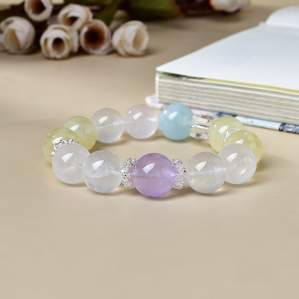 Natural milky quartz bracelet front view with amethyst focal bead citrine aquamarine silver flower spacers on beige background white roses crystal healing good luck KaiGuang