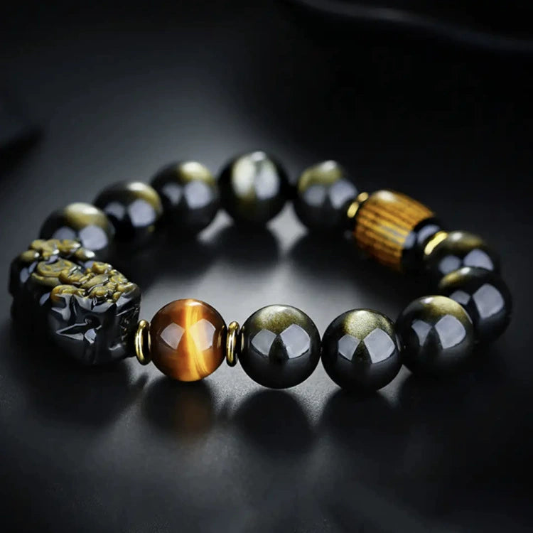 Natural gold obsidian Pixiu KaiGuang bracelet with tiger eye and Taoist rune bead on dark background