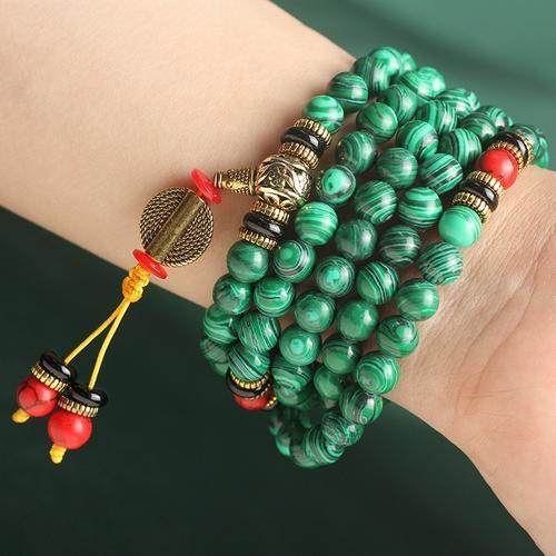 Full view of 108 natural malachite beads with red turquoise accents for emotional balance.