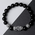 Silver Pixiu obsidian money bracelet worn by man and woman couple lifestyle shot Taoist KaiGuang wealth guardian jewelry
