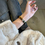 Woman wearing obsidian tiger eye protection strength bracelet casual lifestyle white fluffy coat denim jeans silver spacer bead natural crystal jewelry