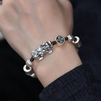 Lifestyle image showing the Pixiu wealth bracelet worn on a wrist, demonstrating real daily wear effect.