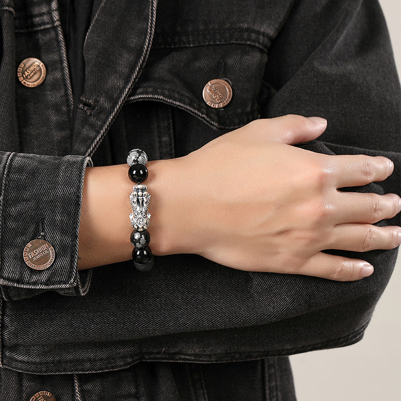  Pixiu obsidian Taoist KaiGuang wealth bracelet worn on wrist with black denim jacket showing fit and silver Pixiu detail