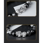Silver Pixiu charm close up detail and obsidian volcanic stone KaiGuang bracelet full view on black background with gold frame