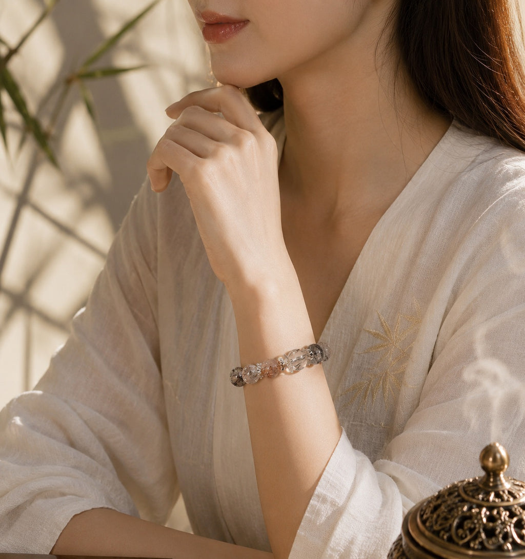 Asian woman wearing black rutilated quartz strawberry quartz protection grounding bracelet white linen dress sunlight bamboo shadow background Taoist KaiGuang