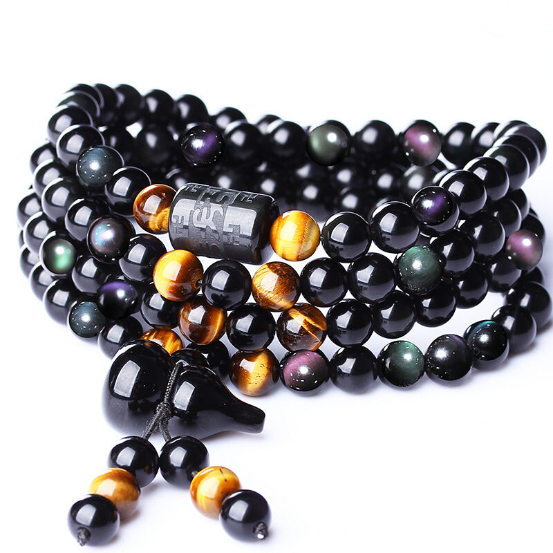 Rainbow eye obsidian 108 bead Taoist KaiGuang bracelet on white background showing engraved pendant and tassel detail