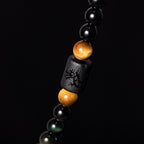  Rainbow eye obsidian bead closeup showing iridescent halo surface spiritual protection stone