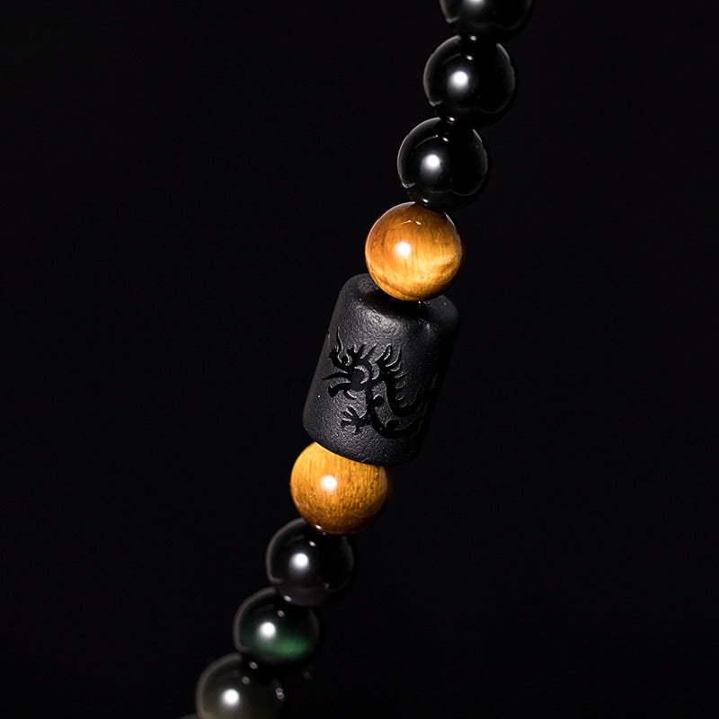  Rainbow eye obsidian bead closeup showing iridescent halo surface spiritual protection stone