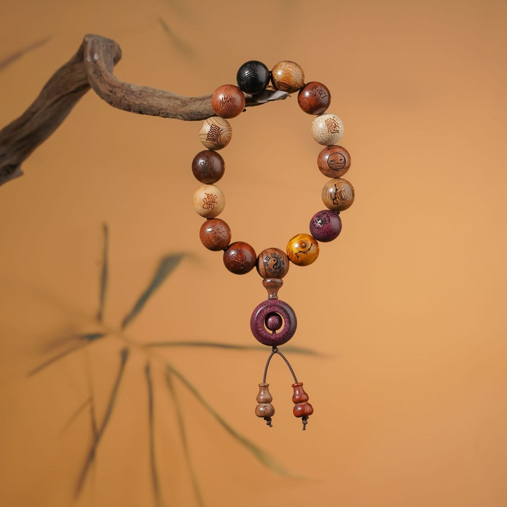 Red sandalwood beads with gold-painted Tai Chi Bagua symbols on a traditional stand, designed as a functional tool for energy balance.