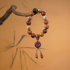 Red sandalwood beads with gold-painted Tai Chi Bagua symbols on a traditional stand, designed as a functional tool for energy balance.