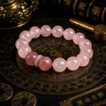 Rose quartz heart chakra bracelet with strawberry quartz focal bead silver spacers on Taoist bagua plate bronze background KaiGuang self-love manifestation