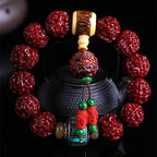 Nepal Rudraksha protection bracelet with carved copper bead and colorful Tibetan cinnabar pendant displayed before iron teapot Taoist KaiGuang evil ward jewelry