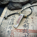 Front view of the Taoist Talisman Pendant featuring supreme protection symbols filled with sacred cinnabar for evil-banishing.