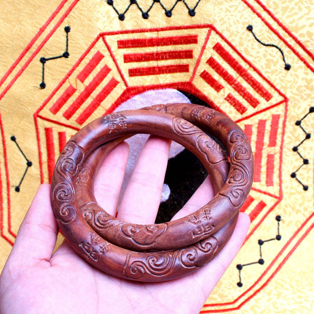 The Supreme Yin-Yang Ring resting on a rustic wood surface, acting as a functional energy shield that creates an unbroken loop of pure yang energy.