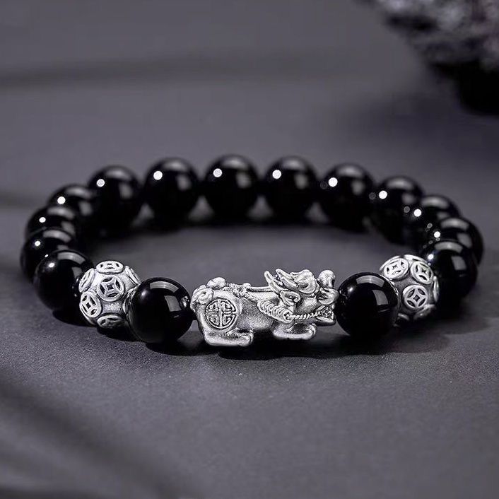 Natural obsidian stone Pixiu money bracelet resting on dark rock silver guardian beads Longhu Mountain KaiGuang consecrated