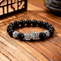 Silver Pixiu obsidian money bracelet with hollow guardian fortune beads on dark gray background Taoist KaiGuang wealth jewelry