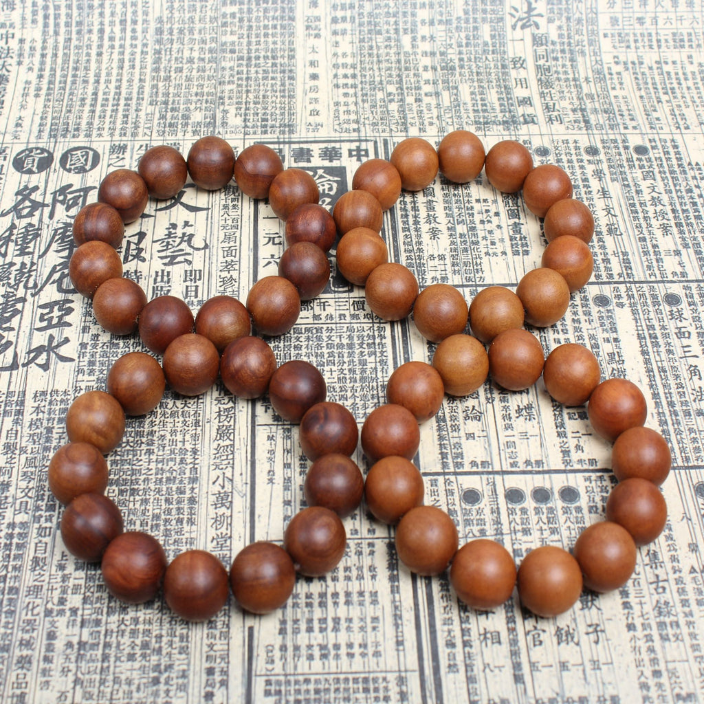 High-density dark aged wood beads for spiritual defense and protection.