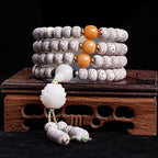 Star moon bodhi 108 bead meditation mala four wrap with yellow beeswax beads white jade lotus pendant colorful tassel on carved rosewood stand Taoist KaiGuang cosmic alignment mindfulness tool